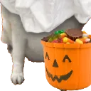 A ghost covered in a white sheet holds an orange jack-o'-lantern bucket filled with assorted candies.