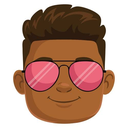 Person with brown skin and dark hair wearing bright pink sunglasses and smiling.
