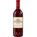 Red wine bottle standing upright against a dark background.