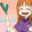 Anime girl with orange hair smiling while spinning a green leek in a rhythmic motion.
