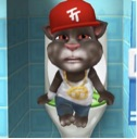 A 3D cat wearing a red baseball cap and gold chain sitting on a toilet with a bored and annoyed expression.