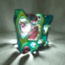 A glowing, multi-colored 3D cube with organic, pulsing textures set against a dark background.