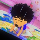 A cartoon avatar with curly hair and a goatee resting their head down in exhaustion.