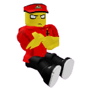 A blocky yellow character with a red hat and shirt sits with arms crossed and a stern expression.