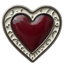 Heart shaped jewelry piece with a deep red center and an intricate silver filigree border.