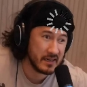 A man wearing headphones with a white digital loading wheel icon superimposed on his forehead.