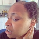 A woman looking off-camera with a confused and skeptical facial expression.