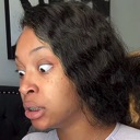 Woman with wide eyes looking off-camera in a state of shock and disbelief.