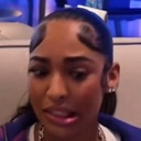 Woman looking at the camera with a skeptical, confused expression and furrowed brows.