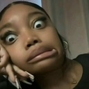 A woman with wide, startled eyes and a pursed, distorted mouth looking directly at the camera.