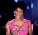 A woman in a pink top wags her finger while saying the words you aint shit.