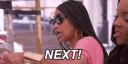 Woman wearing sunglasses and a pink shirt dismissively waving her hand with the text NEXT! overlaid.