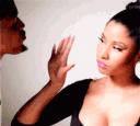 Nicki Minaj performs a talk-to-the-hand gesture with a dismissive expression.