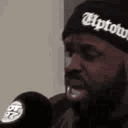 Man wearing an Uptown beanie nodding while speaking the words that's mother fuckin'.