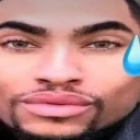 A man's face in a wide-angle, distorted perspective with a single blue teardrop on the right side.