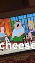 Peter Griffin sits on a talk show set with his mouth wide open in a loud, boisterous laugh.
