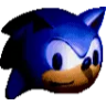 A close-up of a blue hedgehog face with a blank, suspicious expression in low lighting.