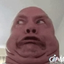A person's face captured in a wide-angle, distorted close-up with a confused and shocked expression.