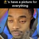 Man with a headset looking down with heavy eyelids and a skeptical expression.