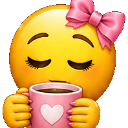 A yellow smiley face with closed eyes wearing a pink bow and holding a pink mug with a heart on it.