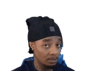 A man wearing a black beanie looking at the camera with a skeptical and unimpressed expression.