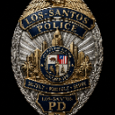 Police badge with gold and silver metallic details and text reading Los Santos Police.