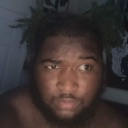A man looking to the side with a suspicious and confused facial expression.