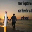 A cigarette stands on a beach next to a silhouetted couple holding hands at sunset with text about loyalty.
