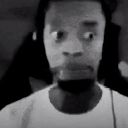 A man with wide, darting eyes and a tight-lipped expression looking suspicious.