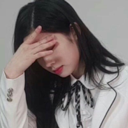 Woman covering her face with her hand in a gesture of disappointment.