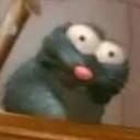 A gray 3D creature with massive, wide-open eyes and a small pink nose looking startled and confused.