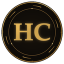A circular badge with a dark background and gold trim featuring the letters HC in light blue.