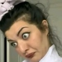 Woman with a wide-eyed, skeptical expression looking intensely at the camera.