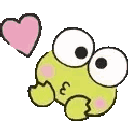 A small green frog character blowing a kiss with a pink heart, then shyly covering its face with its hands.