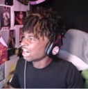 Man with dreadlocks and headphones looking shocked with wide eyes and an open mouth.