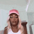 Woman with blonde hair and a pink cap rhythmically nodding her head in a repeating loop.