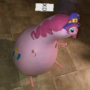 A round pink balloon-like creature with a small head and limbs stands on a tiled floor with the text XD floating above it.