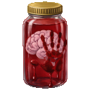 A brain floating in a red liquid inside a glass jar with a bloody handprint on the front.