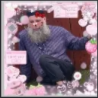 A man with a long beard sits in a pink, flower-decorated frame.