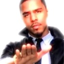 J. Cole holds his hand out toward the camera in a stop gesture.