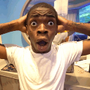 Man with wide eyes and mouth open in shock holding his head with both hands.