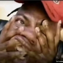 A man pulling his face with his hands to create a distorted, shocked expression.