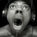 Man with headphones wearing a shocked expression with his mouth wide open.