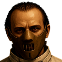 A man with a serious expression wearing a metal muzzle-style mask.