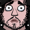 A bearded man with wide, circular eyes looking directly forward in a state of shock.