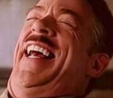 J. Jonah Jameson laughing with his head tilted back and eyes closed.
