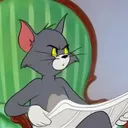 LD_A_TomLookingUpFromNewspaper