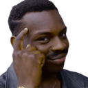 Man taps his temple with a smug expression on his face.