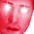 Face with glowing white laser eyes and a high-contrast red filter.