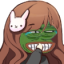 An anime girl with brown hair and a bunny clip wearing a green Pepe the Frog mask with a wide, toothy grin.